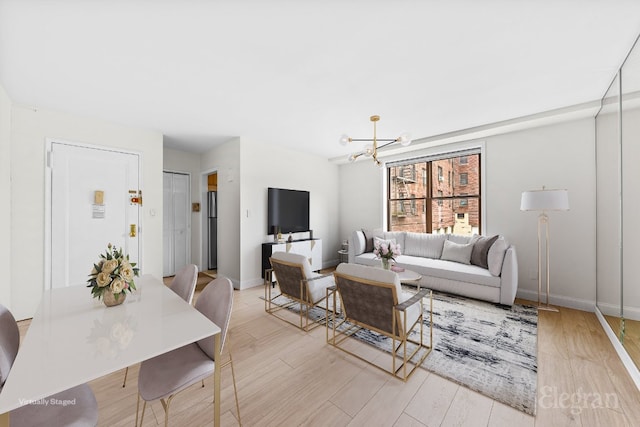 living room with a notable chandelier and light hardwood / wood-style floors