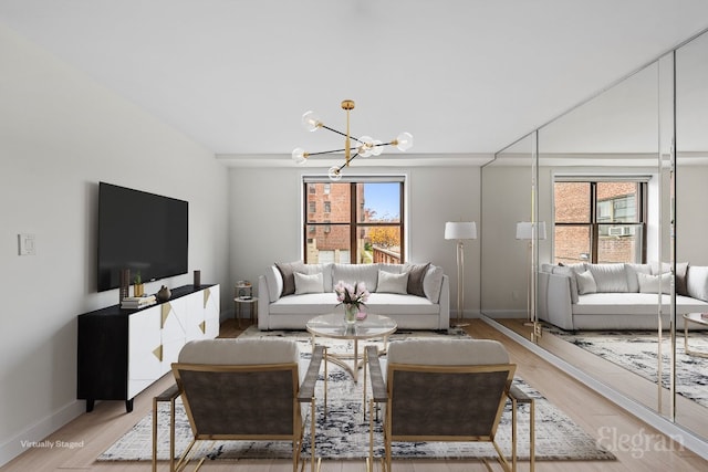 living room with light wood-type flooring and a chandelier