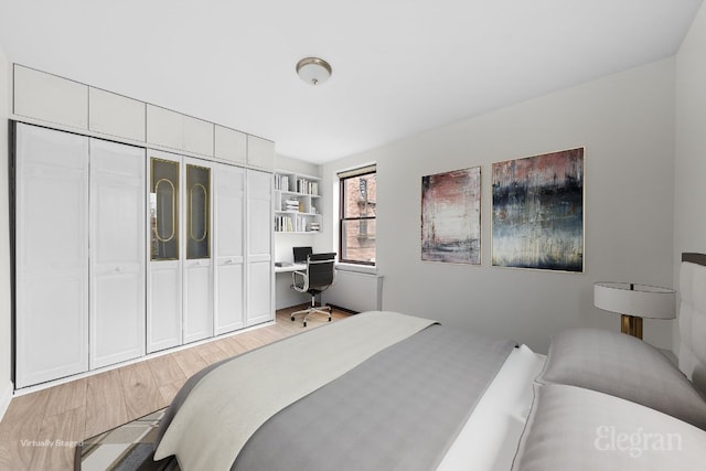 bedroom with a closet and light hardwood / wood-style flooring