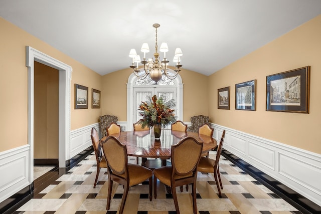 dining space featuring an inviting chandelier and lofted ceiling