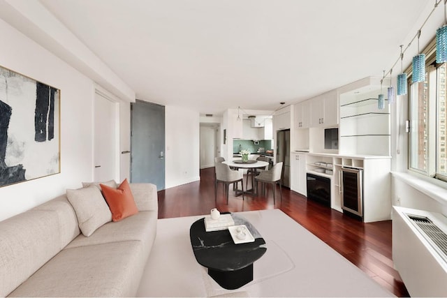 living room with dark hardwood / wood-style floors and wine cooler