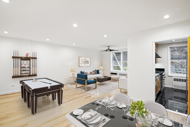 rec room featuring recessed lighting, radiator heating unit, light wood-style floors, a ceiling fan, and baseboards