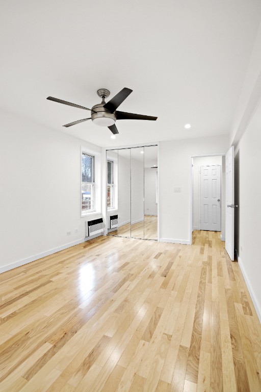 unfurnished bedroom featuring recessed lighting, light wood-type flooring, baseboards, and a ceiling fan