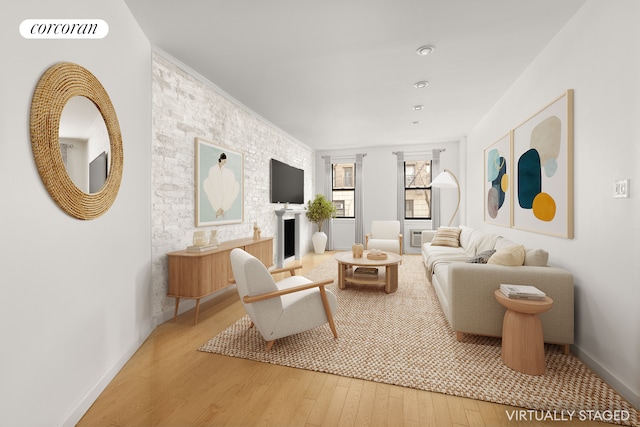 living area featuring baseboards, a fireplace, visible vents, and wood finished floors