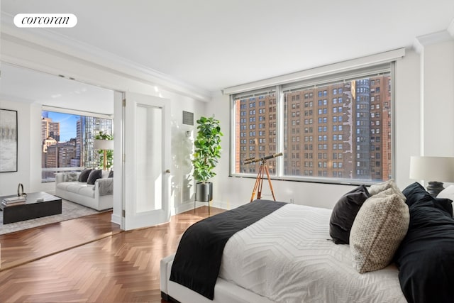 bedroom with a view of city, ornamental molding, and visible vents