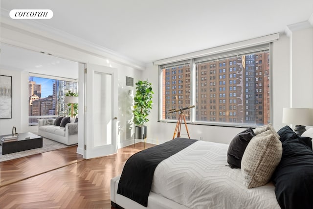 bedroom with visible vents, crown molding, and a city view