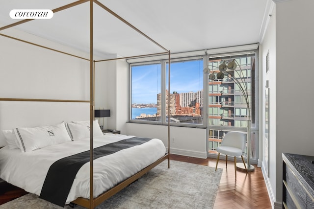 bedroom featuring baseboards, visible vents, and a city view