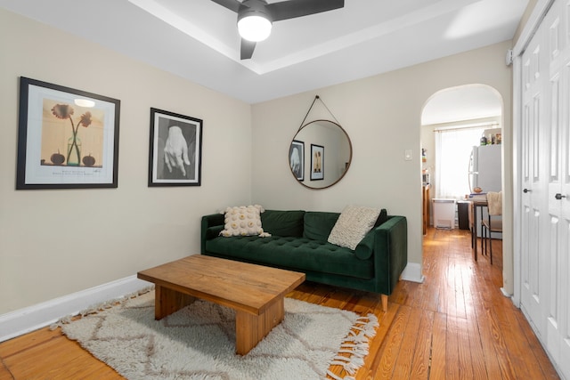 464 5th St, New York City, NY 11215 - living room with arched walkways, light wood-style flooring, ceiling fan, and baseboards