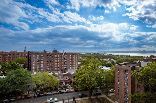 view of building exterior with a water view and a view of city