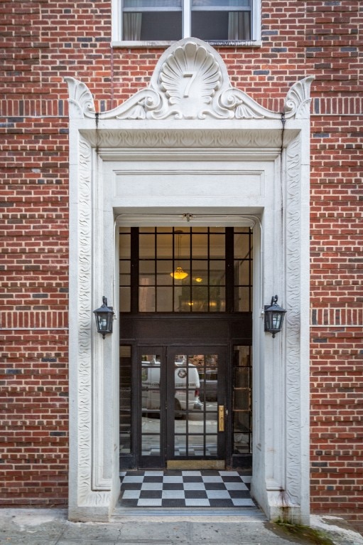 view of exterior entry with brick siding