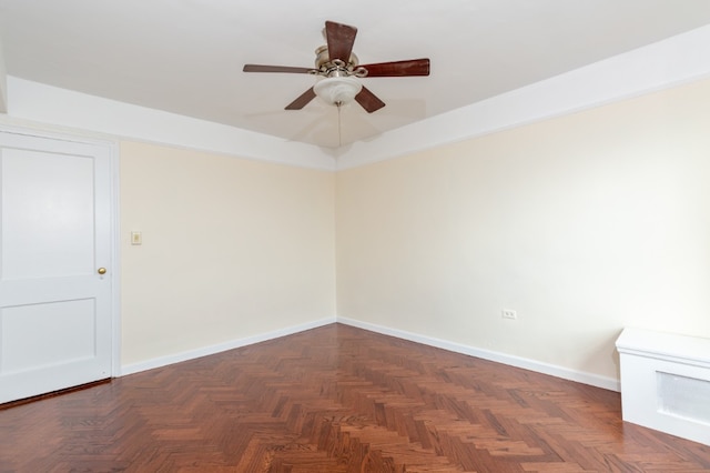 empty room featuring a ceiling fan and baseboards