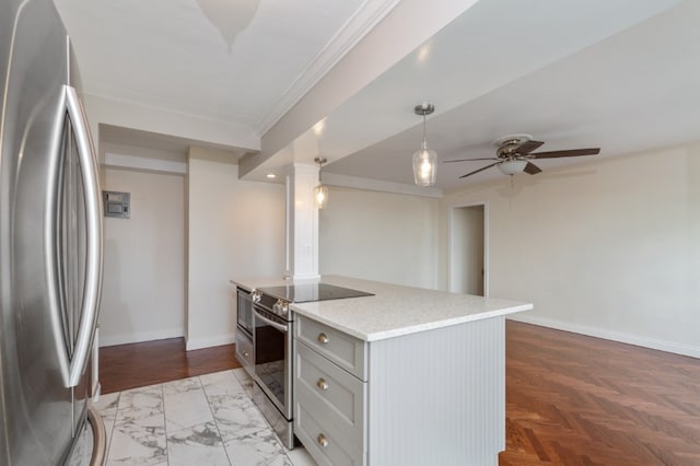 kitchen featuring a ceiling fan, baseboards, appliances with stainless steel finishes, and light stone counters