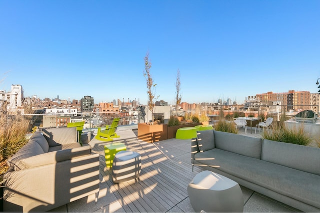 wooden terrace with an outdoor hangout area and a view of city