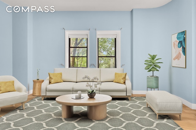 living room featuring wood finished floors and baseboards