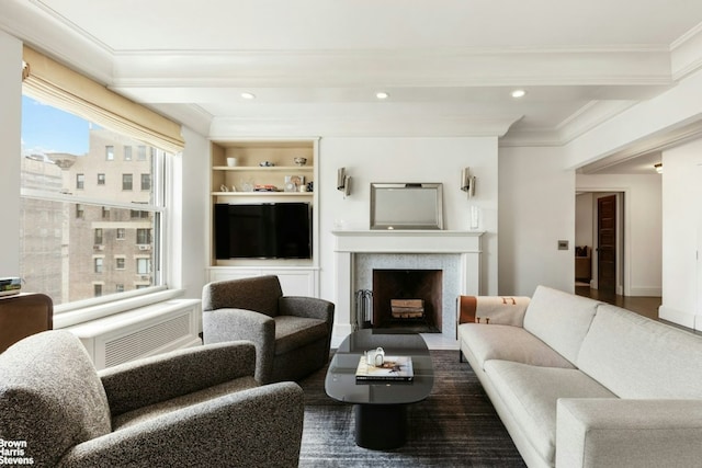 living room featuring beamed ceiling, ornamental molding, and built in features