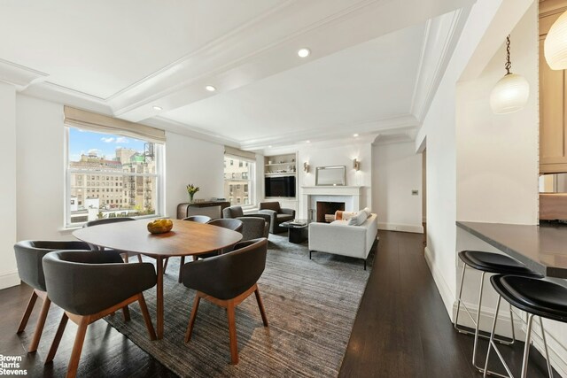 8 E 96th St Unit 14C, New York City, NY 10128 - dining room featuring recessed lighting, ornamental molding, baseboards, dark wood-style floors, and a fireplace