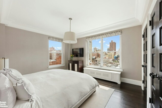 8 E 96th St Unit 14C, New York City, NY 10128 - bedroom featuring dark wood-type flooring, ornamental molding, and baseboards