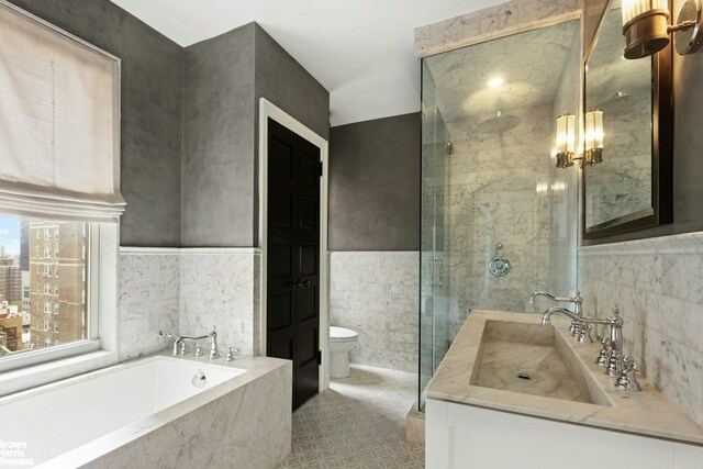 8 E 96th St Unit 14C, New York City, NY 10128 - bathroom with vanity, tile walls, toilet, a stall shower, and a bath