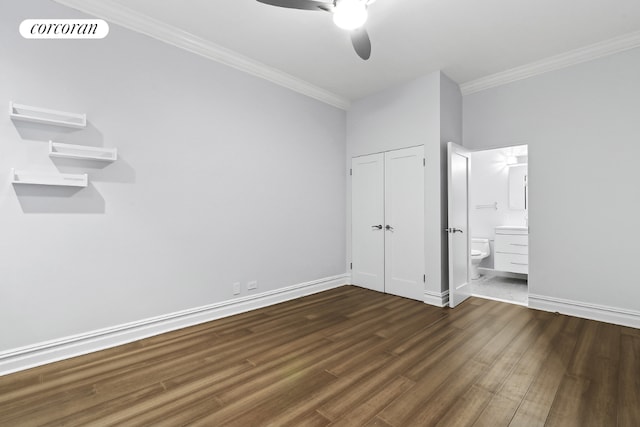 unfurnished bedroom featuring dark wood-type flooring, ceiling fan, crown molding, and ensuite bath