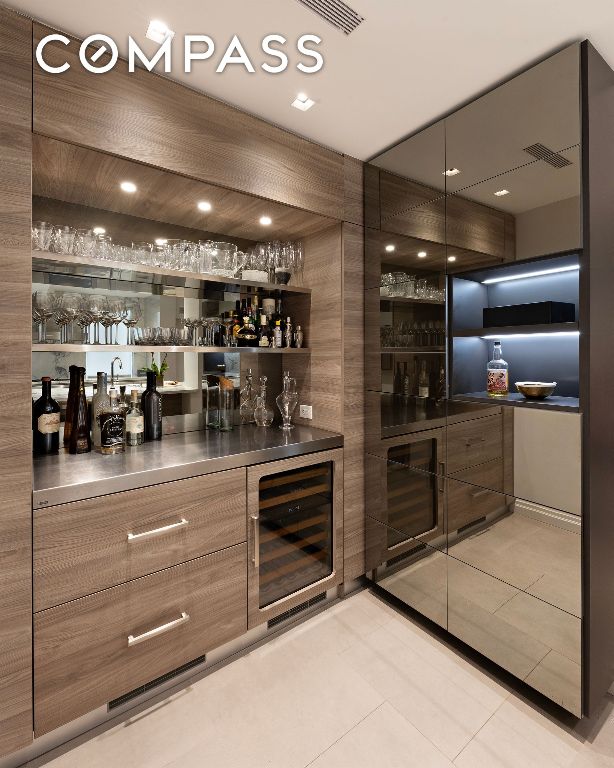 bar with wine cooler, visible vents, a dry bar, and light tile patterned floors