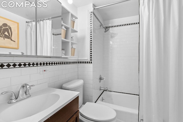 full bathroom with tile walls, toilet, vanity, and shower / bath combination with curtain