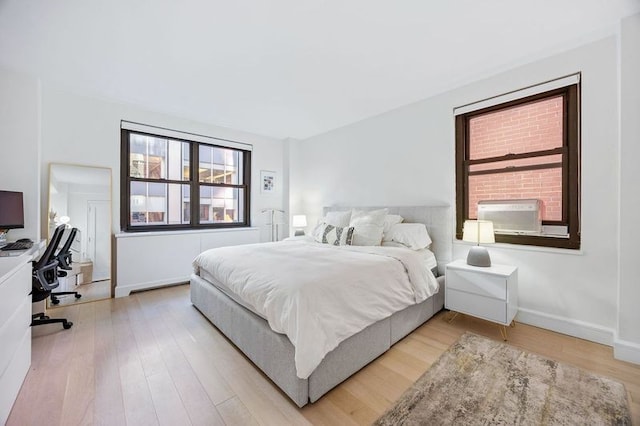 bedroom featuring wood-type flooring and cooling unit