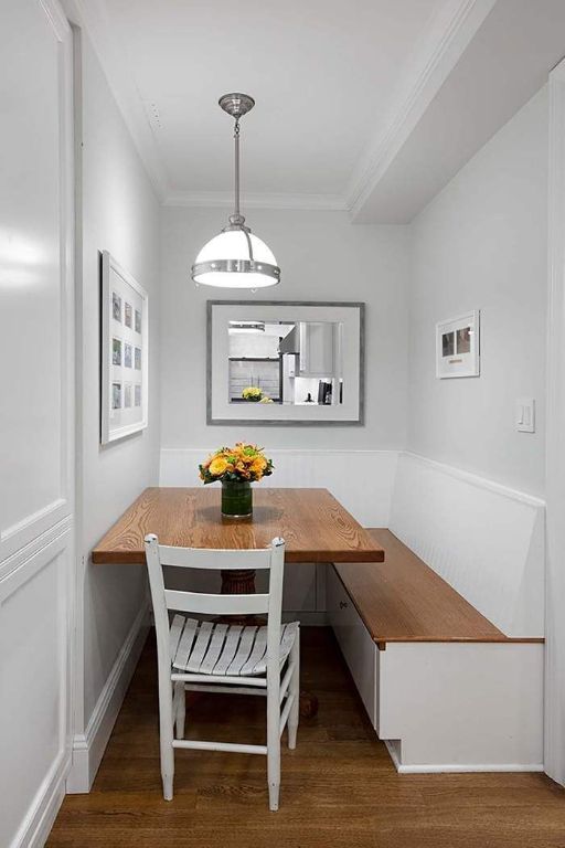 dining area featuring dark hardwood / wood-style flooring, crown molding, and breakfast area