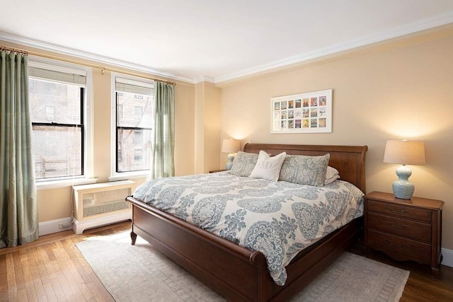 bedroom featuring crown molding and hardwood / wood-style floors