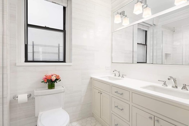 bathroom with tile walls, toilet, and vanity