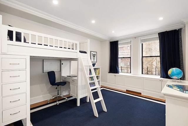 bedroom featuring ornamental molding, built in desk, and dark hardwood / wood-style flooring