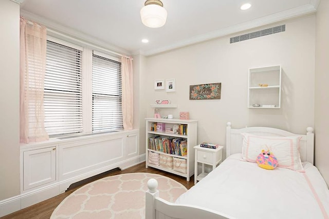 bedroom featuring dark wood-type flooring and crown molding