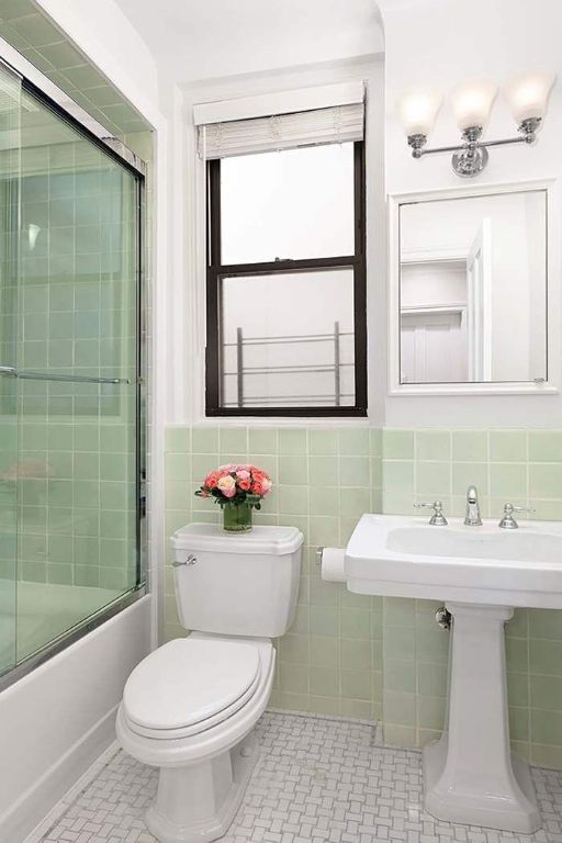 bathroom featuring tile patterned flooring, enclosed tub / shower combo, tile walls, and toilet