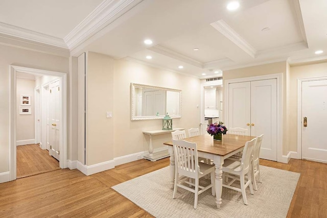 dining space featuring ornamental molding and light hardwood / wood-style floors