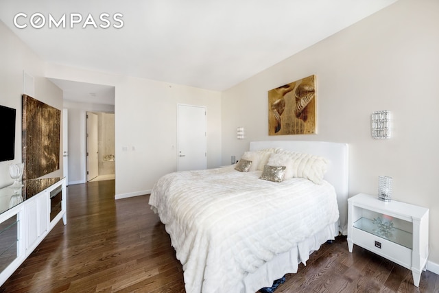 bedroom with baseboards and wood finished floors