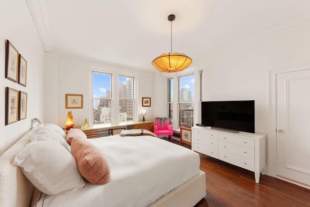 bedroom featuring wood finished floors and crown molding