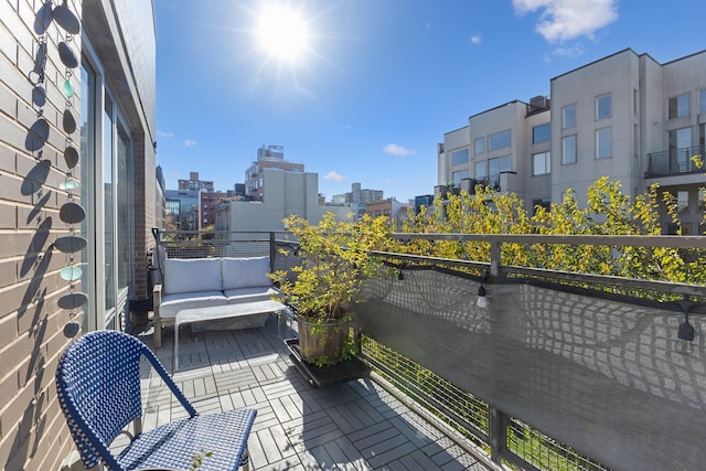 balcony with a city view and outdoor lounge area