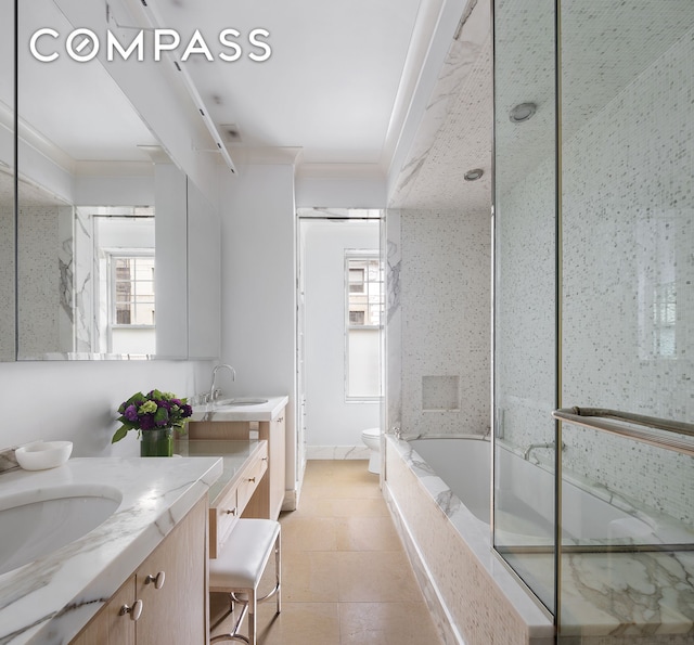 full bath featuring a washtub, crown molding, toilet, vanity, and tile patterned flooring