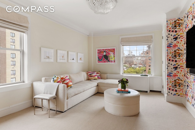 carpeted living room featuring crown molding and baseboards