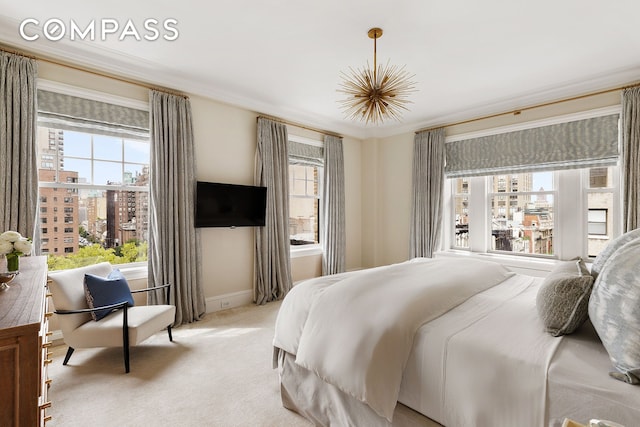 bedroom with light carpet, ornamental molding, and baseboards