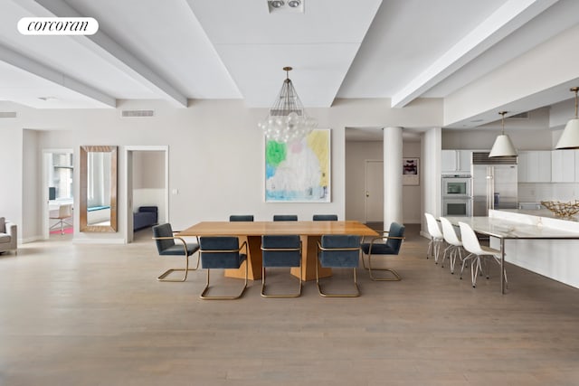 dining space featuring wood-type flooring and beam ceiling