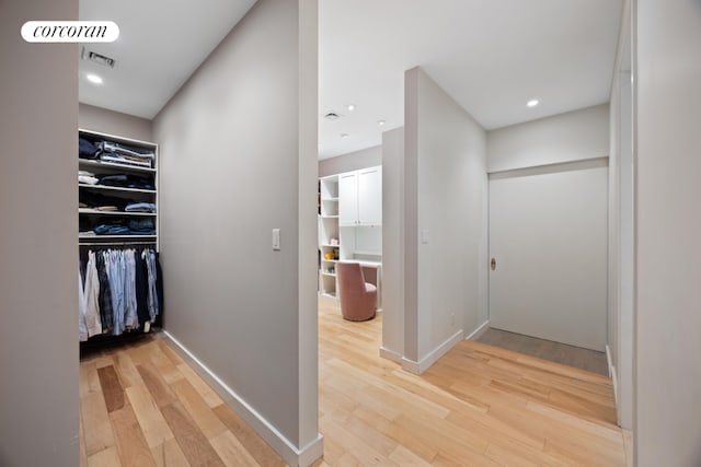 spacious closet featuring hardwood / wood-style flooring