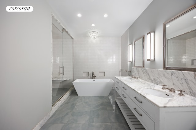 bathroom with vanity, tile walls, and independent shower and bath