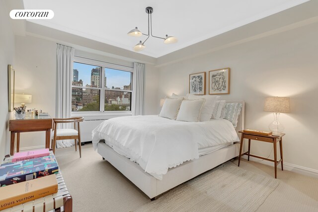 11 5th Ave Unit 9S, New York City, NY 10003 - bedroom with carpet flooring, a chandelier, baseboards, and a city view