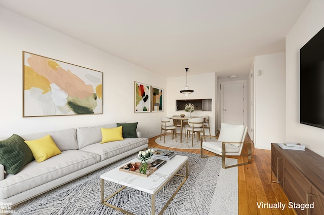 living room featuring wood finished floors and baseboards