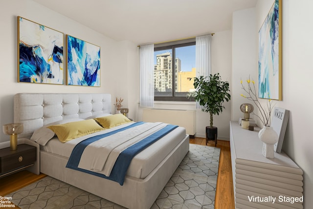 515 E 72nd St Unit 4A, New York City, NY 10021 - bedroom featuring wood finished floors, baseboards, and radiator heating unit