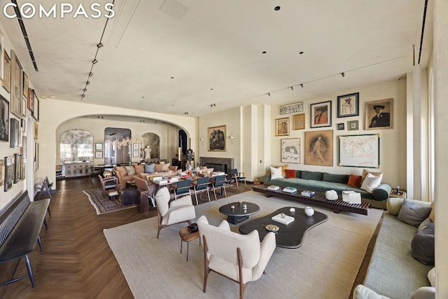 living room featuring dark parquet flooring and track lighting