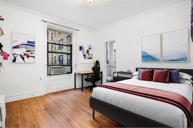 bedroom featuring light wood-type flooring, baseboards, cooling unit, and crown molding