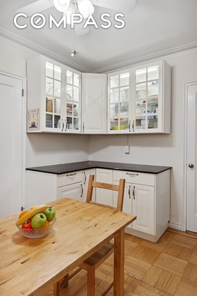 50 Park Ter E Unit 7E, New York City, NY 10034 - kitchen with white cabinetry, glass insert cabinets, and dark countertops