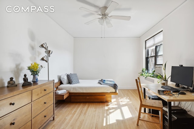 bedroom featuring a ceiling fan, light wood-style flooring, and baseboards