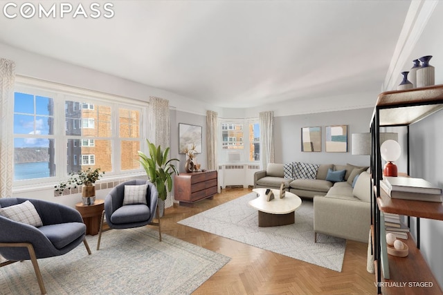 living room featuring radiator, plenty of natural light, and light parquet flooring